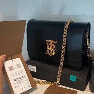 Authentic Burberry black leather with gold chain can wear cross body or side